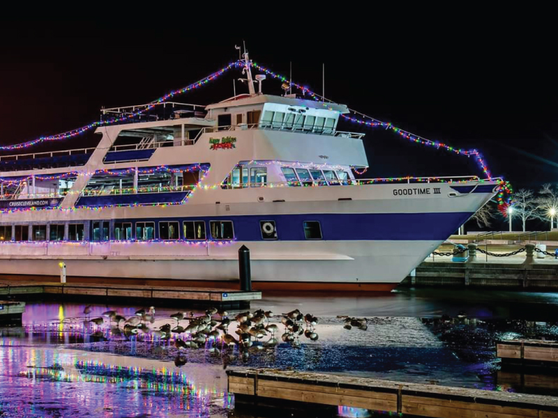nighttime view of the goodtimeiii boat, with decorative lights around it