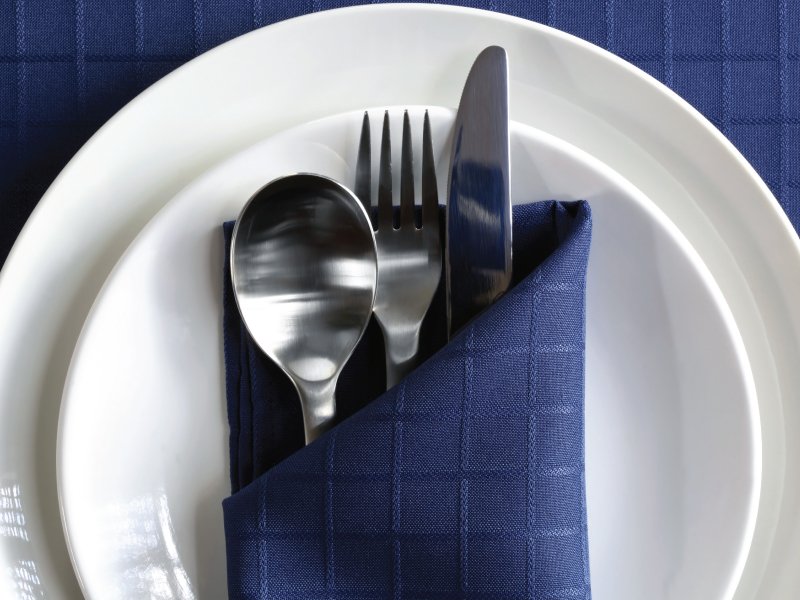utensils on a napkin, on a plate