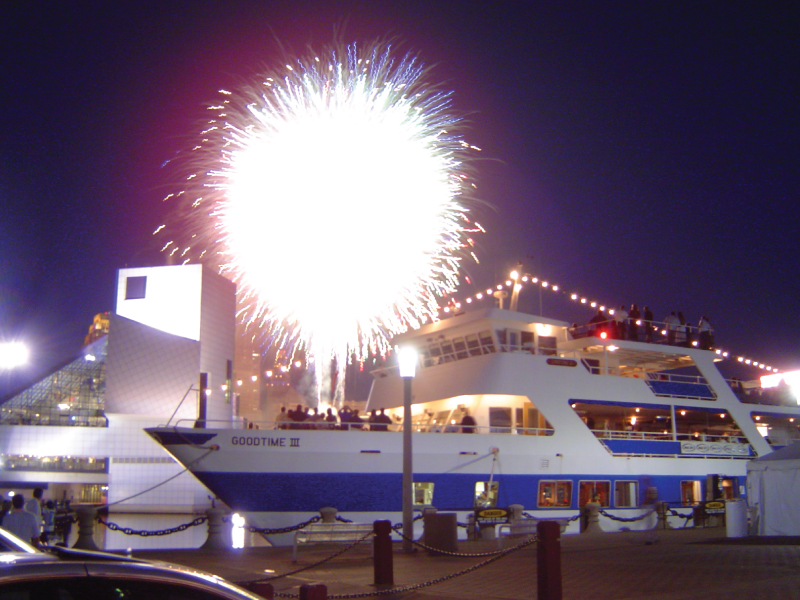 goodtimeiii boat, docked at the pier, with a firework going off in the background
