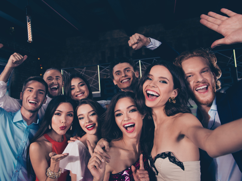 group of people, smiling and taking a selfie together
